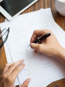 Unrecognizable man filling application form